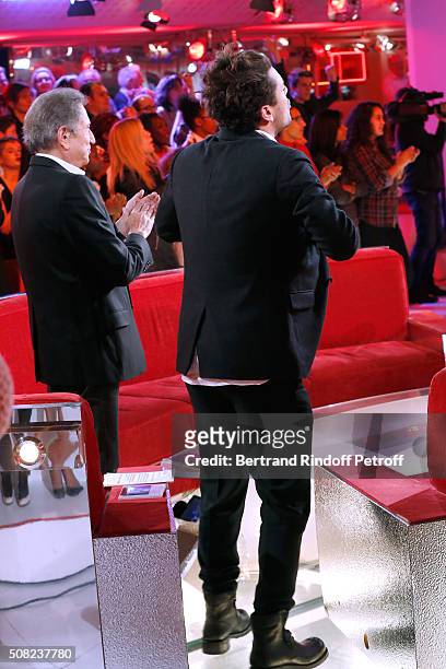 Presenter of the show Michel Drucker and Youngest Main Guest of the Show, Actor and Humorist Kev Adams dance whyle Singer Black M performs during the...