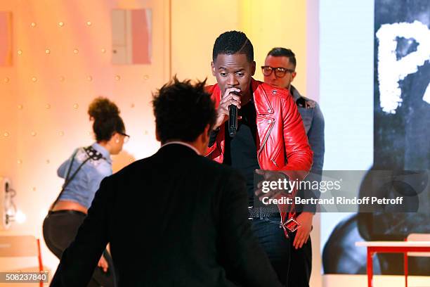 Youngest Main Guest of the Show, Actor and Humorist Kev Adams dances whyle Singer Black M performs during the 'Vivement Dimanche' French TV Show at...