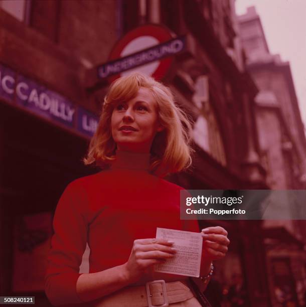 Actress Anne Lawson in front of an Underground station in London in 1965.