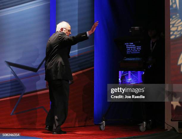 Democratic Presidential candidates Sen. Bernie Sanders waves as he walks off stage after a CNN and the New Hampshire Democratic Party hosted...