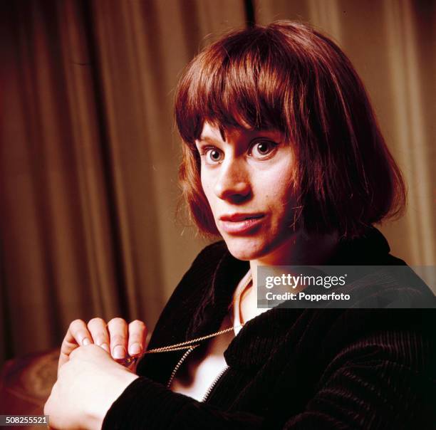 English actress Rita Tushingham posed holding a necklace in 1965.