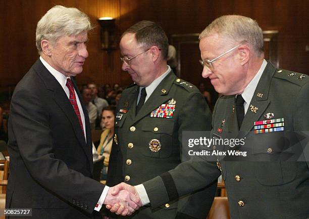 Chairman of the Senate Armed Services Committee U.S. Sen. John Warner shakes hands with U.S. Army Judge Advocate General Maj. General Thomas Romig...