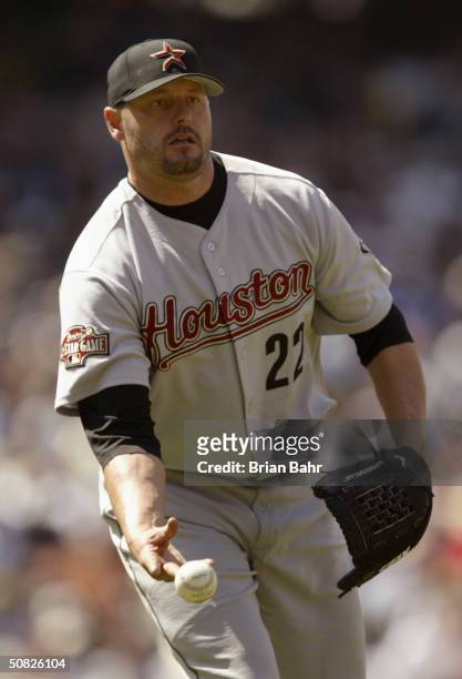 Roger Clemens of the Houston Astros tosses the ball to first base during the game against the Colorado Rockies at Coors Field on April 24, 2004 in...