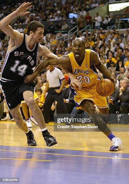 Gary Payton of the Los Angeles Lakers drives past Hedo Turkoglu of the San Antonio Spurs during Game four of the Western Conference Semifinals during...