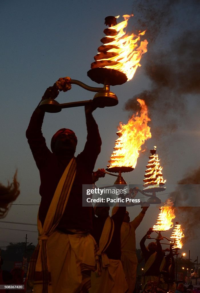Priest rotates the traditional oil lamp as he offers evening...