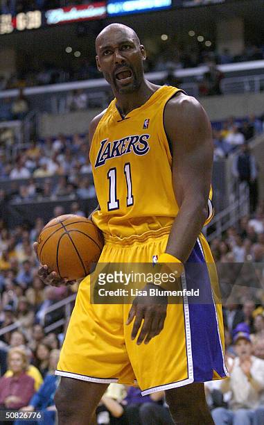 Karl Malone of the Los Angeles Lakers reacts to a call during Game four of the Western Conference Semifinals against the San Antonio Spurs during the...