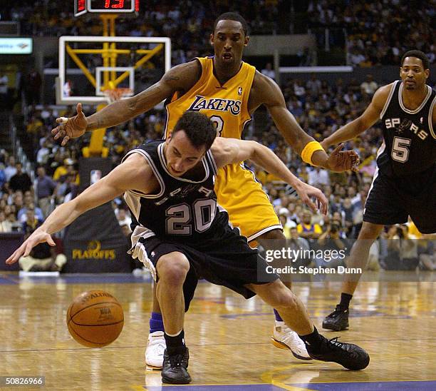 Manu Ginobili of the San Antonio Spurs goes after a loose ball under pressure from Kobe Bryant of the Los Angeles Lakers in Game four of the Western...