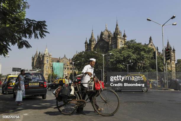 Dabbawala Dadabhau Shivaji transports lunch bags on his bicycle near Chtrapati Shivaji terminusin Mumbai, India, on Tuesday, Dec. 22, 2015. Food...