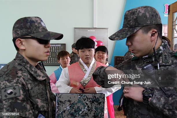 Graduating students of Daeseong-dong Elementary School attend the graduation ceremony as escorted by South Korean soldiers on February 4, 2016 in...