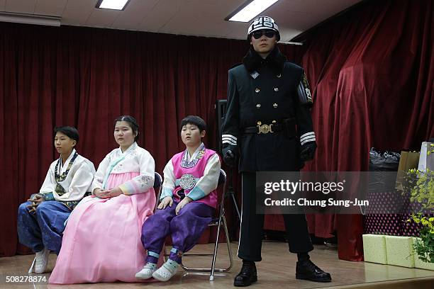Graduating students of Daeseong-dong Elementary School attend the graduation ceremony as escorted by South Korean soldiers on February 4, 2016 in...