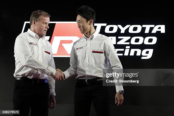 Tommi Makinen, team principal of the Toyota Motor Corp. Gazoo Racing team competing in the FIA World Rally Championship , left, shakes hands with...