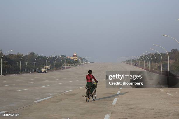 Cyclist rides down an empty 20-lane highway in Naypyidaw, Myanmar, on Wednesday, Feb. 3, 2016. Myanmar's new popularly elected upper house of...