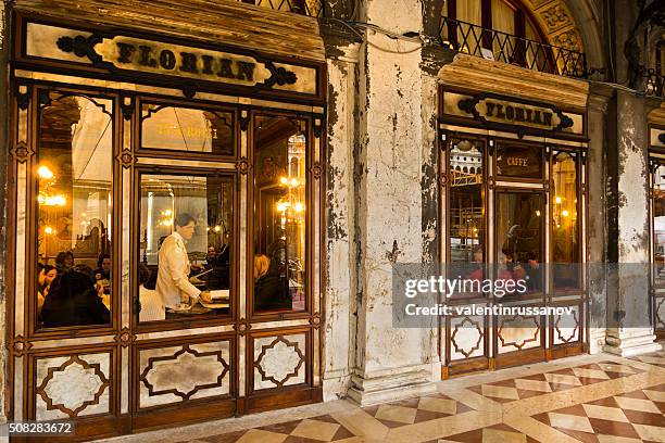 the outside of cafe florian in venice at night - cafe florian stock pictures, royalty-free photos & images