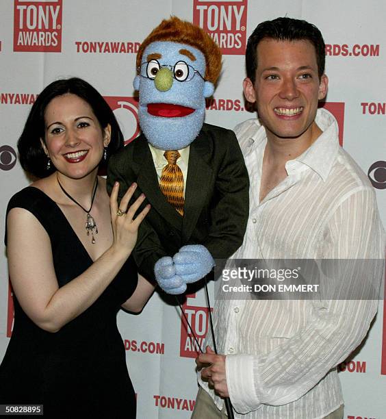 Actors Stephanie D'Abruzzo and John Tartaglia pose with one of the puppets from "Avenue Q" during a reception for the Tony Award Nominees 12 May,...