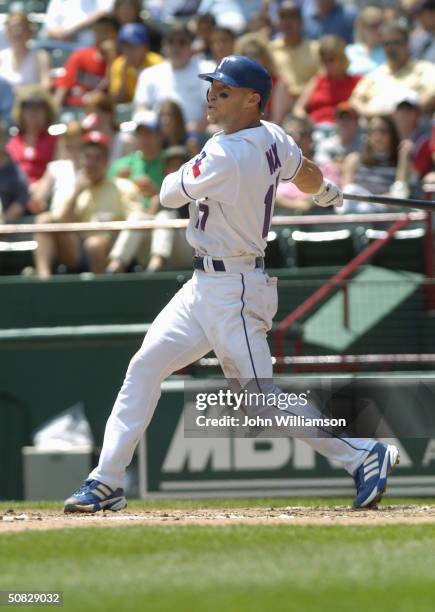 Outfielder Laynce Nix of the Texas Rangers swings at a Seattle Mariners pitch during the MLB game at The Ballpark in Arlington on April 25, 2004 in...