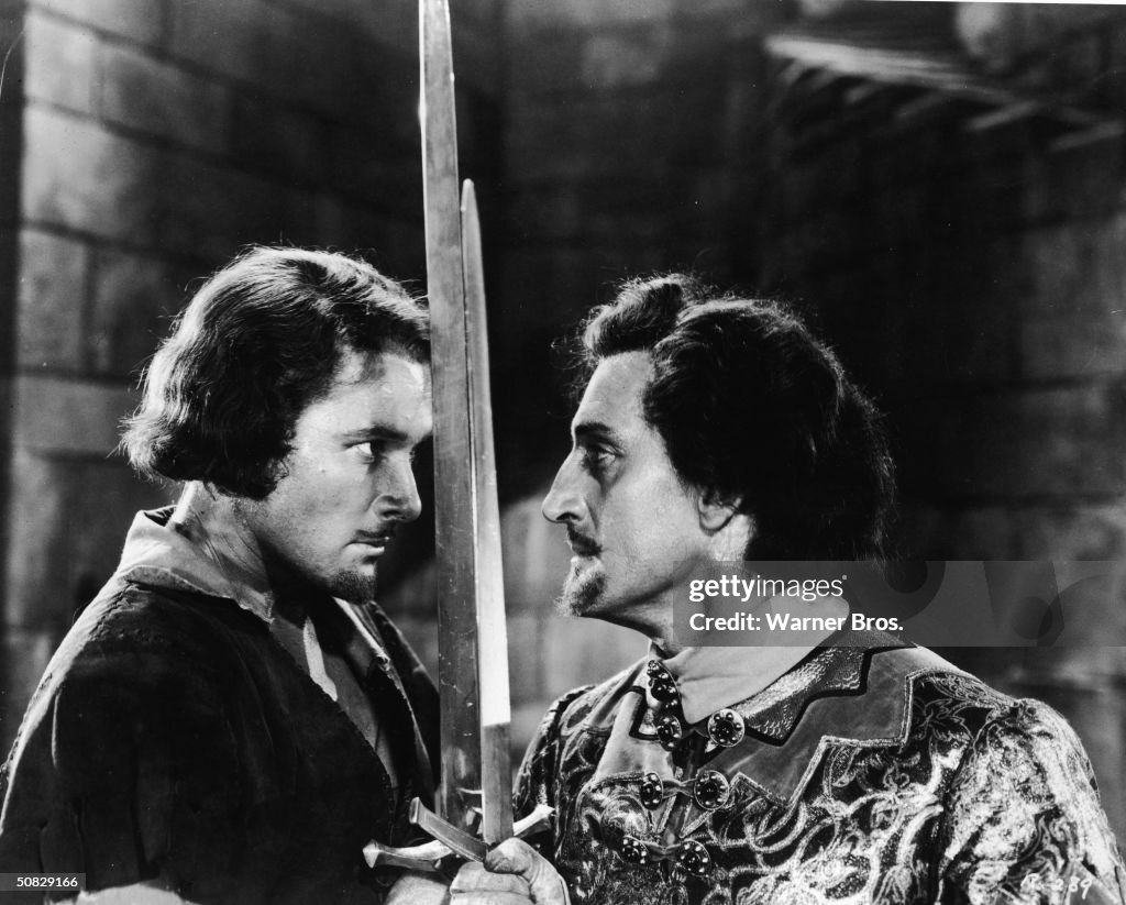 Actors Errol Flynn and Basil Rathbone face off for a duel in a still ...