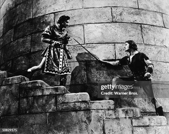 Basil Rk Actors Errol Flynn and Basil Rathbone duel on a castle stairwell in a ...