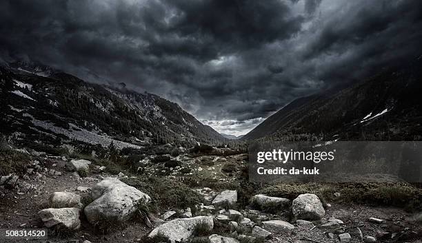 mountains at storm - valley stock pictures, royalty-free photos & images