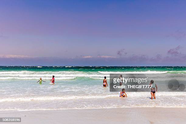 african children enjoying the beach in fish hoek - fish hoek stock pictures, royalty-free photos & images