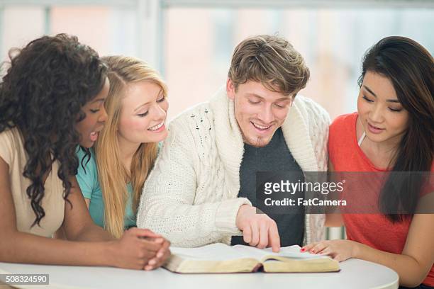 amigos leer un libro juntos - christian college fotografías e imágenes de stock
