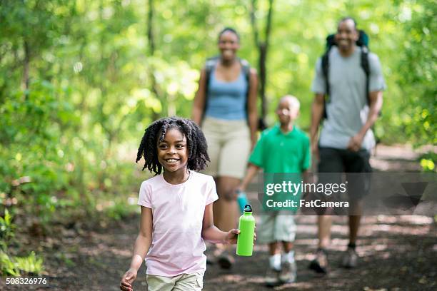 family hiking through the woods - kids hiking stock pictures, royalty-free photos & images