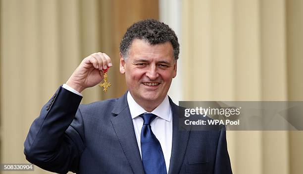 Screenwriter Steven Moffat poses at Buckingham Palace, after being made an OBE for his services to drama by the Prince of Wales on February 4, 2016...