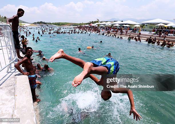 Local residents play at the Whitewater stadium, venue of canoe competition as the local government open th evenue to public six months before the Rio...
