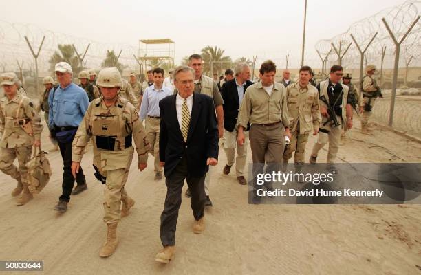 Secretary of Defense Donald Rumsfeld tours the Abu Ghraib Prison Facility with Deputy Director of Detainee Operations in Iraq, Major General Geoffry...