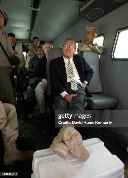 Secretary of Defense Donald Rumsfeld sports a pair of desert camo combat boots as he tours a portion of the notorious Abu Ghraib Prison facility...