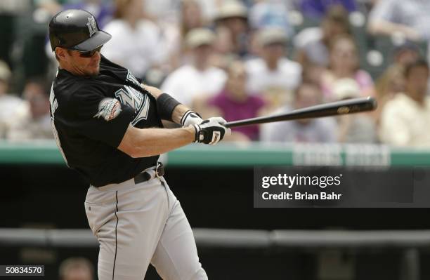 Left fielder Jeff Conine of the Florida Marlins takes a swing during the game against the Colorado Rockies at Coors Field on April 28, 2004 in...