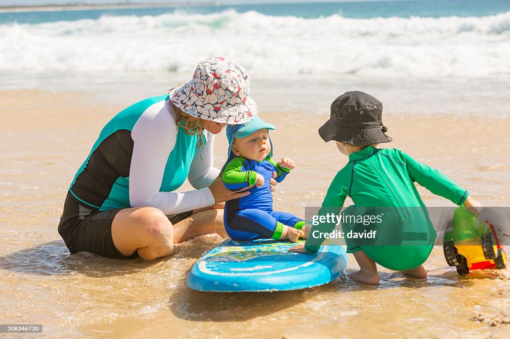 Mother and Young Children Playing at the Beach