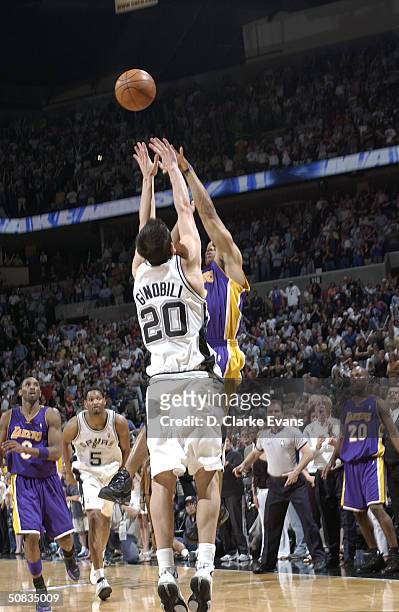 Derek Fisher of the Los Angeles Lakers shoots and makes the game-winning basket against Emanuel Ginobili of the San Antonio Spurs at the buzzer in...