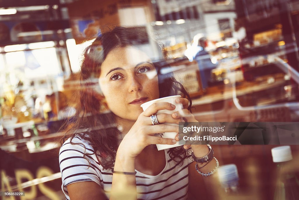 Pensive Beautiful Young Woman Drinking Coffee