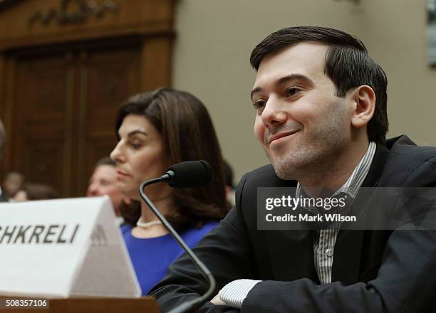 Martin Shkreli, former CEO of Turing Pharmaceuticals LLC., smiles while flanked by Nancy Retzlaff, chief commercial officer for Turing...