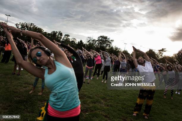 Participants in the Secret Sun Rise event start with a yoga session in the early hours of the morning on February 04, 2016 in Johannesburg, South...