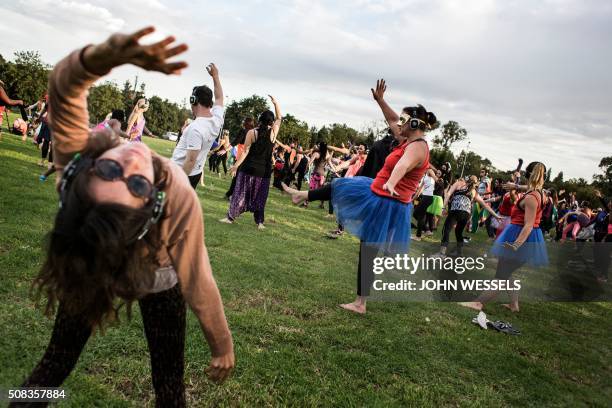 Participants at the Secret Sun Rise event dance with about 300 others in the early hours of the morning on February 04, 2016 in Johannesburg, South...