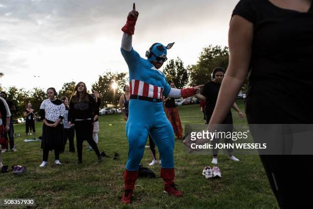 Participants at the Secret Sun Rise event dance with about 300 others in the early hours of the morning on February 04, 2016 in Johannesburg, South...