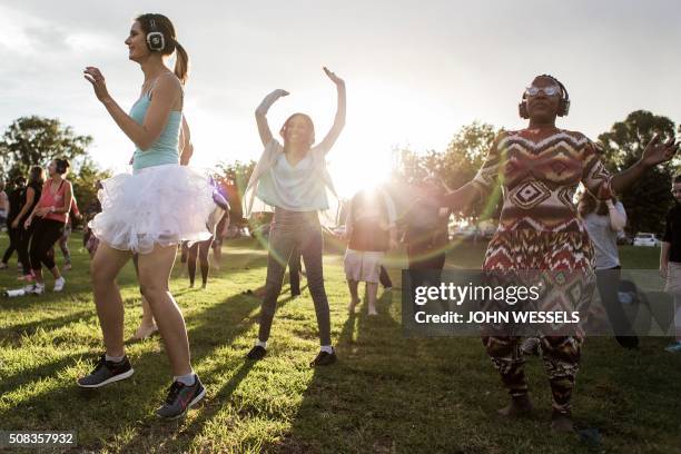 Participants at the Secret Sun Rise event dance with about 300 others in the early hours of the morning on February 04, 2016 in Johannesburg, South...