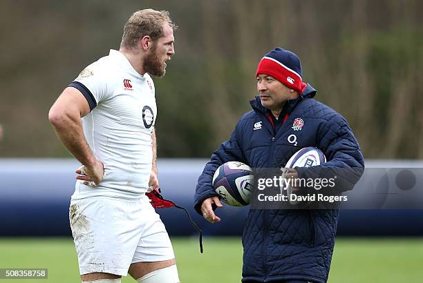 Eddie Jones,the England head coach, talks to James Haskell during the England training session held at Pennyhill Park on February 4, 2016 in Bagshot,...