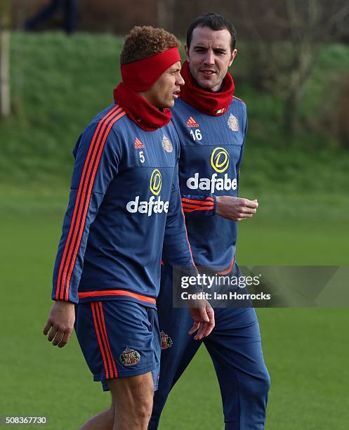 Wes Brown and John O'Shea chat during a Sunderland AFC training session at The Academy of Light on February 04, 2016 in Sunderland, England.