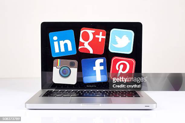 social media logos&icons on macbook pro screen - google social networking service stock pictures, royalty-free photos & images
