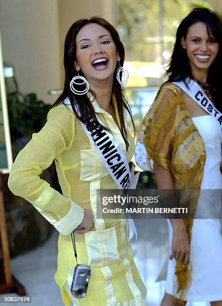 Miss Dominican Republic Larissa del Mar Fiallo and Miss Costa Rica Nancy Soto jocking with photographers in the hotel hall, 14 May 2004 in Quito,...