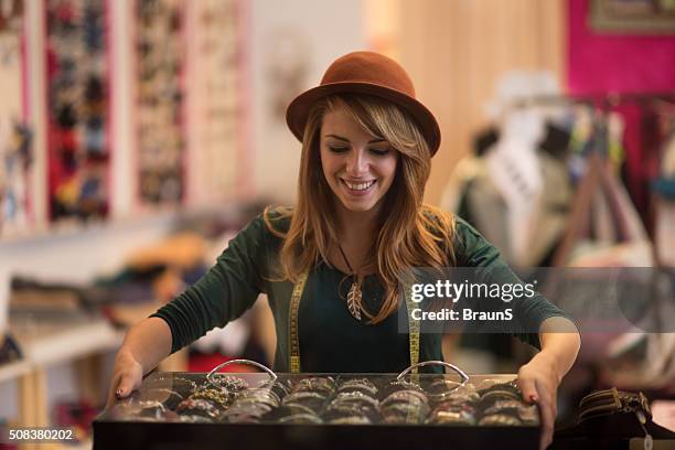 young happy fashion designer working in her store. - bracelet stockfoto's en -beelden