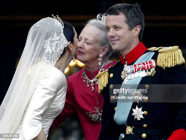 Crown Princess Mary kisses her mother-in-law Queen Margrethe II of Denmark as Crown Prince Frederik looks on as they stand on the balcony of...