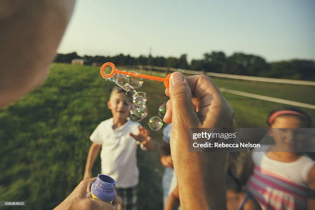 Blowing bubbles to children