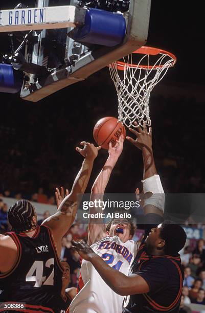 David Lee of the Florida Gators moves up for the basket as he is blocked by Kevin Lyde of the Temple Owls during the IKON Classic at Madison Square...