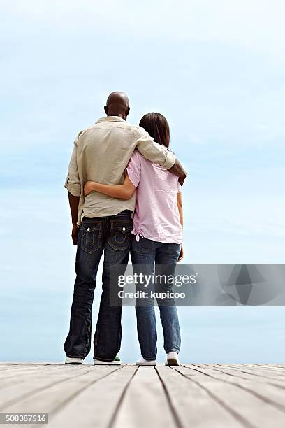 taking in a romantic view - arm around stock pictures, royalty-free photos & images