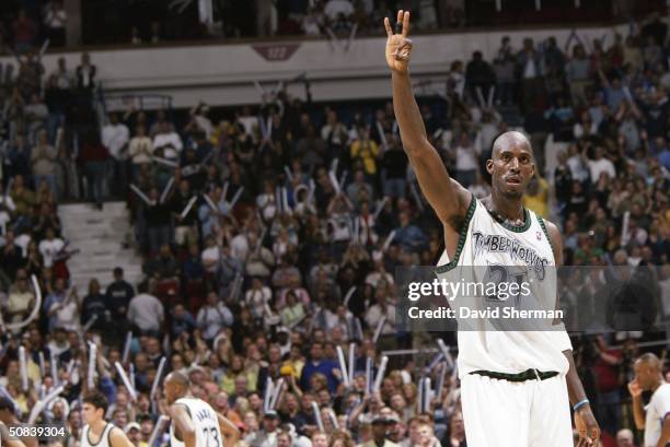 Kevin Garnett of the Minnesota Timberwolves holds up three fingers after winning the game against the Sacramento Kings in Game five of the Western...