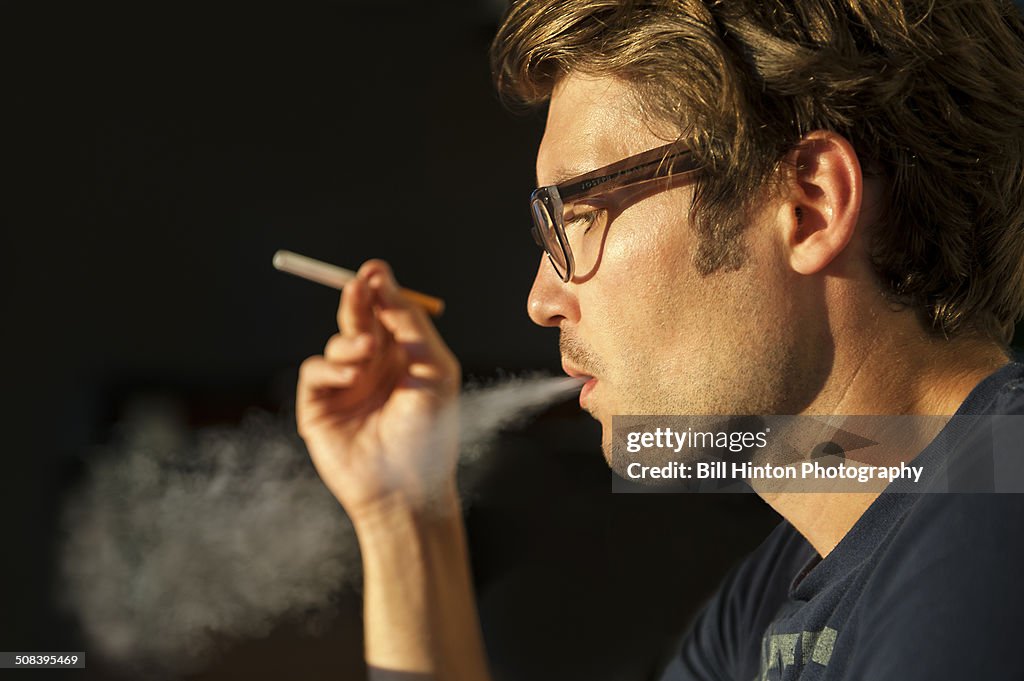 Young man smoking E-cigarette