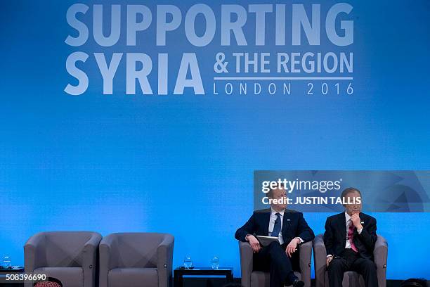 British Prime Minister David Cameron and UN Secretary-General Ban Ki-moon listen seated on the stage during a press conference at the QEII centre in...